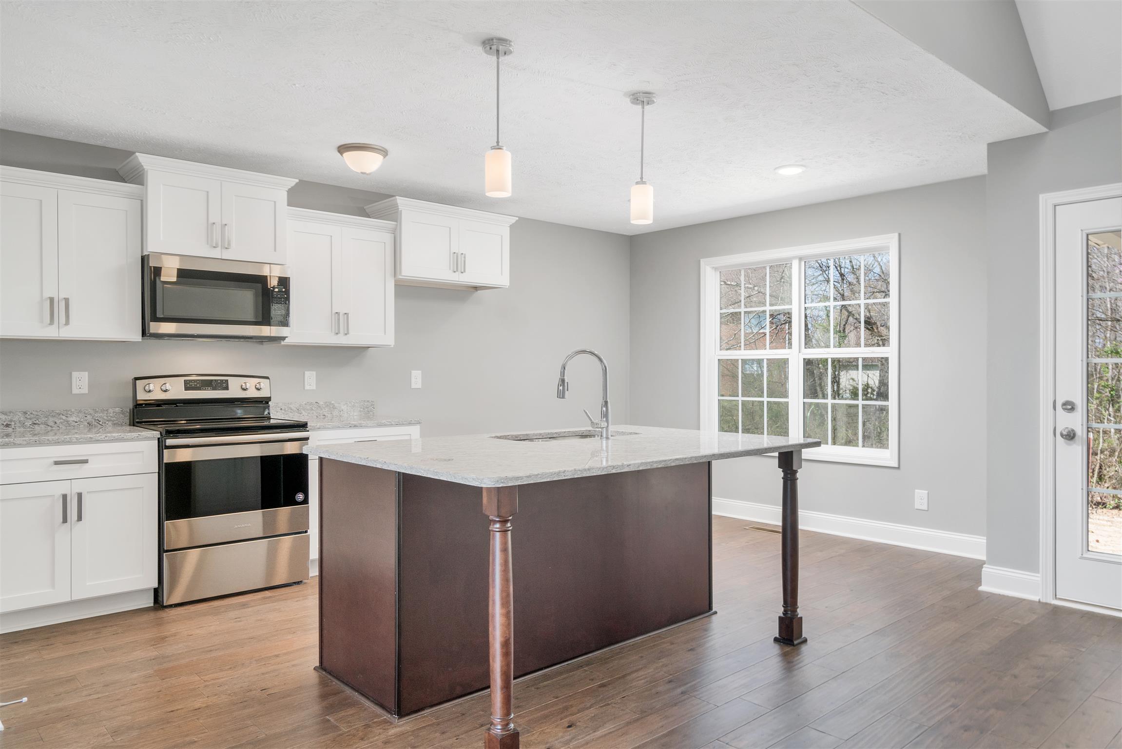 177 Fieldstone Lane Springfield, TN 37172 - Photo 5 of 27 a kitchen with stainless steel appliances a sink a stove a microwave a center island and cabinets