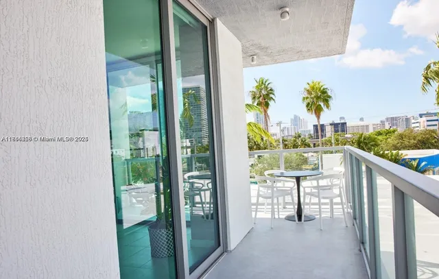 a balcony with table and chairs