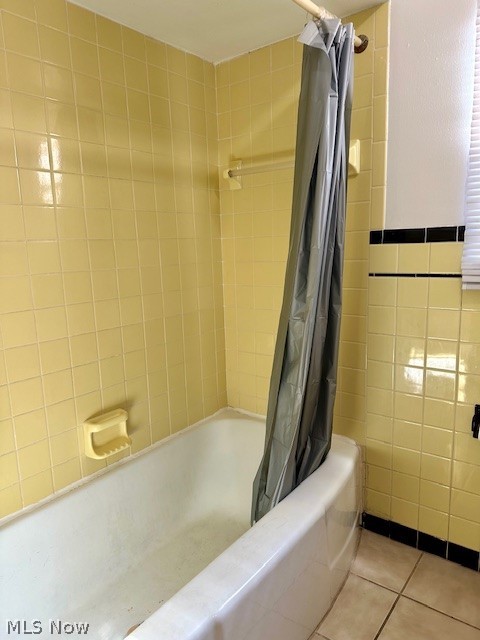 751 Thayer Street, Unit DOWN Akron, OH 44310 - Photo 15 of 25 Bathroom with tile walls, shower / bath combo with shower curtain, and tile patterned floors