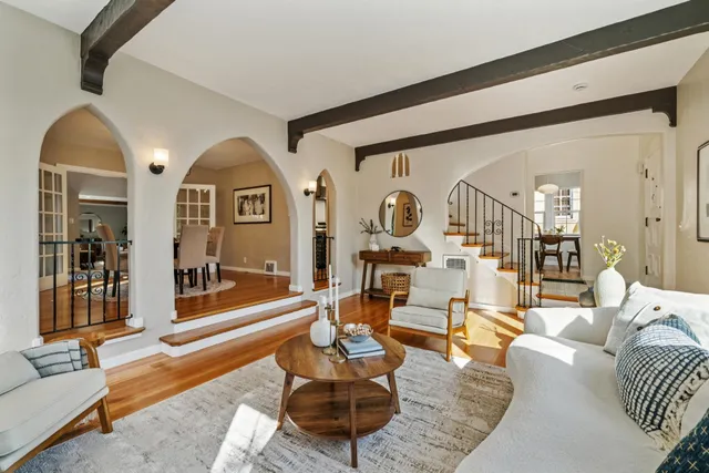 a living room with furniture a rug and white walls
