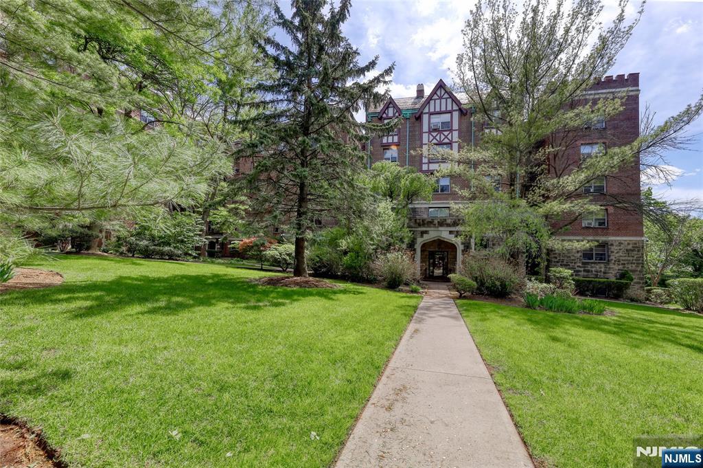 100 East Palisade Avenue, Unit D34 Englewood, NJ 07631 - Photo 2 of 12 a front view of a house with garden