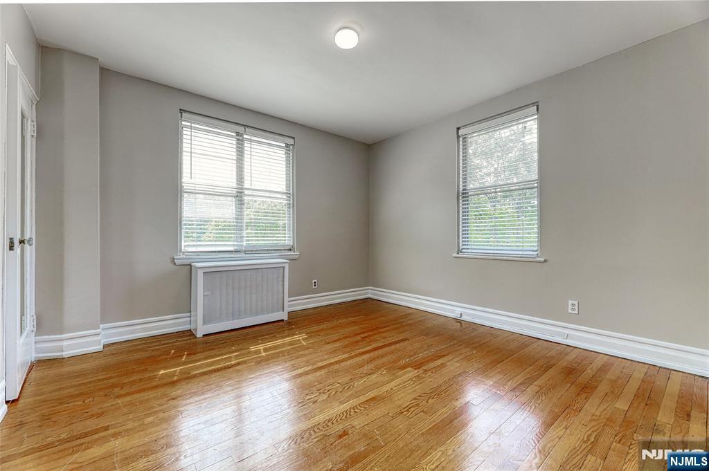 100 East Palisade Avenue, Unit D34 Englewood, NJ 07631 - Photo 8 of 12 an empty room with wooden floor and windows