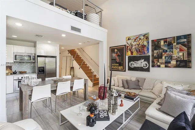 a living room with furniture and kitchen view