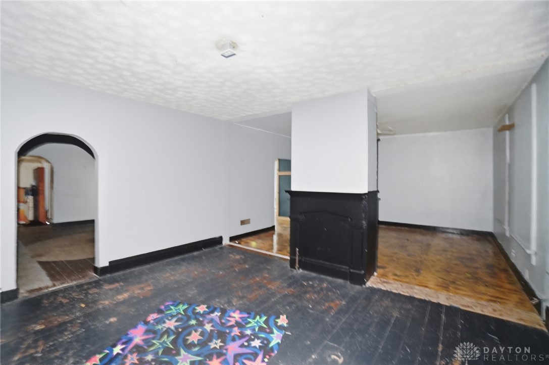 517 Broadway Street, Unit 515 Springfield, OH 45504 - Photo 18 of 29 This versatile space offers potential for customization and comfort, featuring hardwood flooring and a classic fireplace.