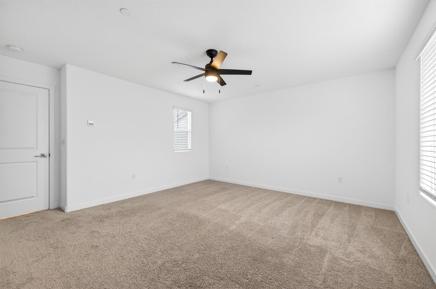 317 Talus Way South Madera, CA 93636 - Photo 28 of 61 an empty room with a window and a ceiling fan