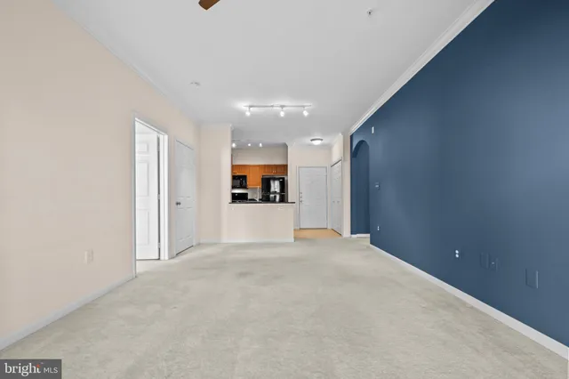 a view of a kitchen with a sink and a refrigerator