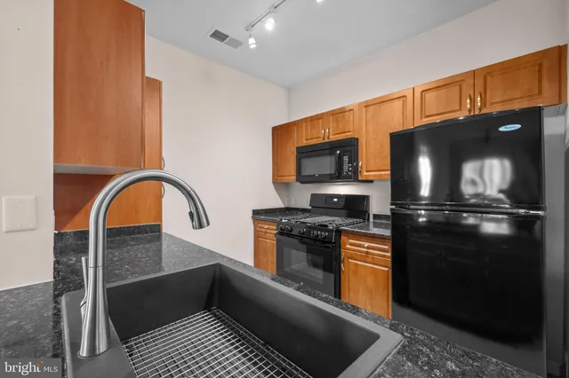 a kitchen with a refrigerator stove and a sink