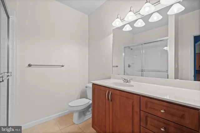 a bathroom with a toilet a sink and a mirror