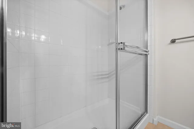 a bathroom with a glass shower door