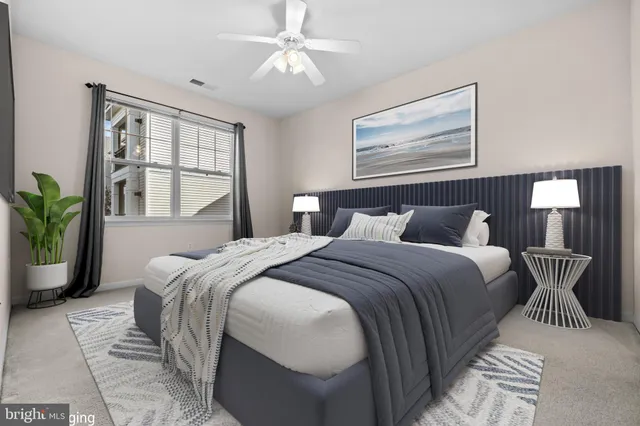 a bedroom with a large bed and windows