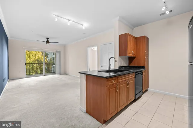 a kitchen with stainless steel appliances granite countertop a sink and a stove