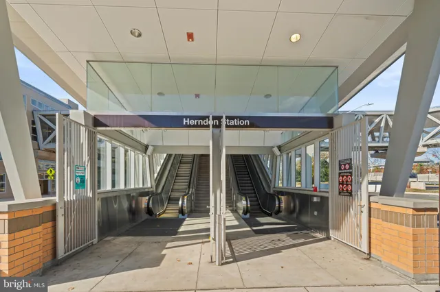 a view of a hallway with wooden floor and windows