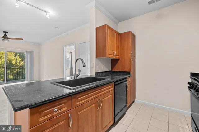 a kitchen with granite countertop a sink and a stove