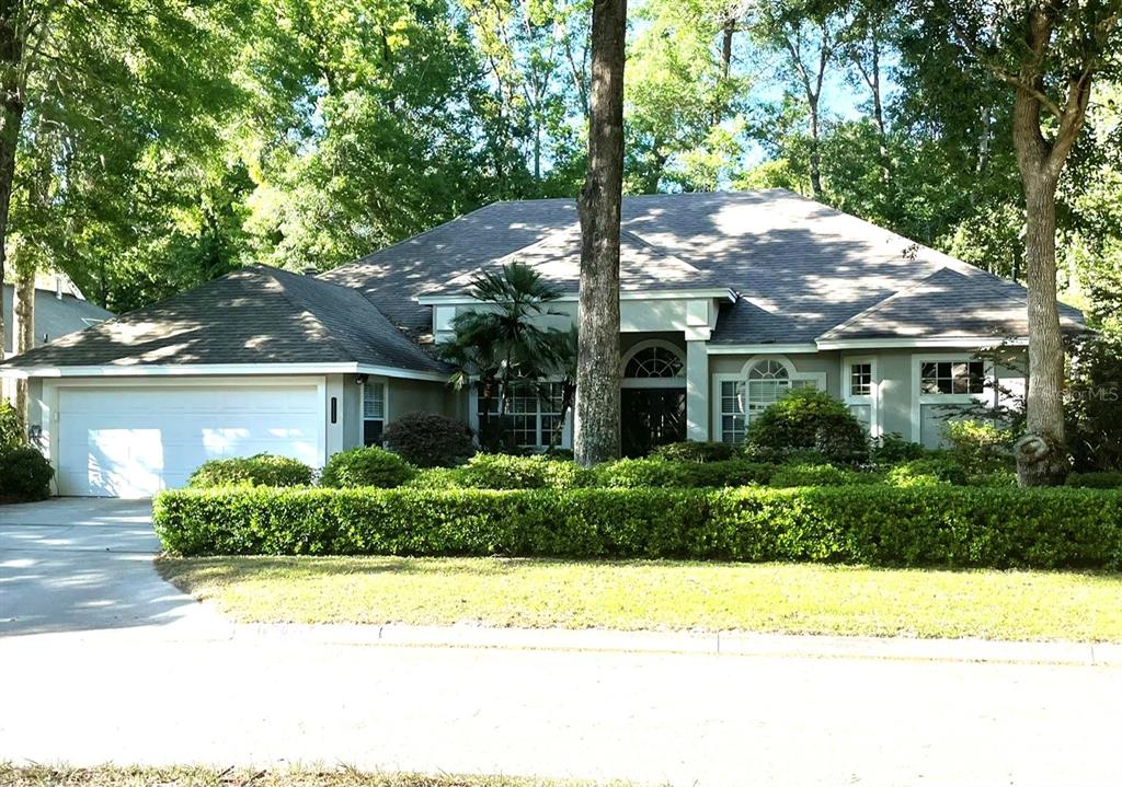 10328 Southwest 49th Lane Gainesville, FL 32608 - Photo 1 of 1 a front view of a house with a yard