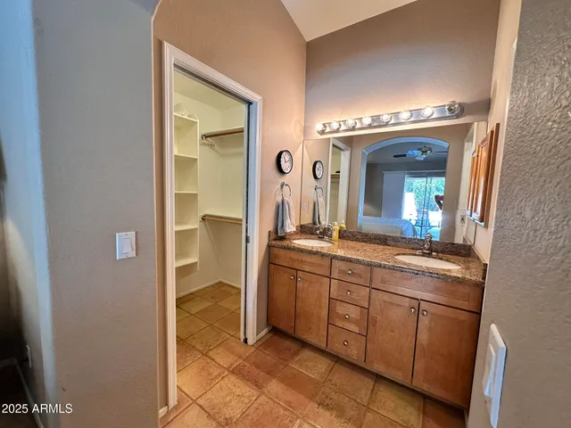a spacious bathroom with a mirror and a sink