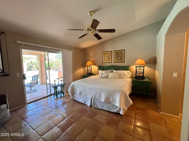 a bedroom with a bed wooden floor and window