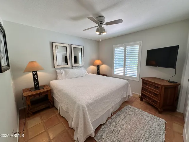 a bedroom with bed and flat screen tv