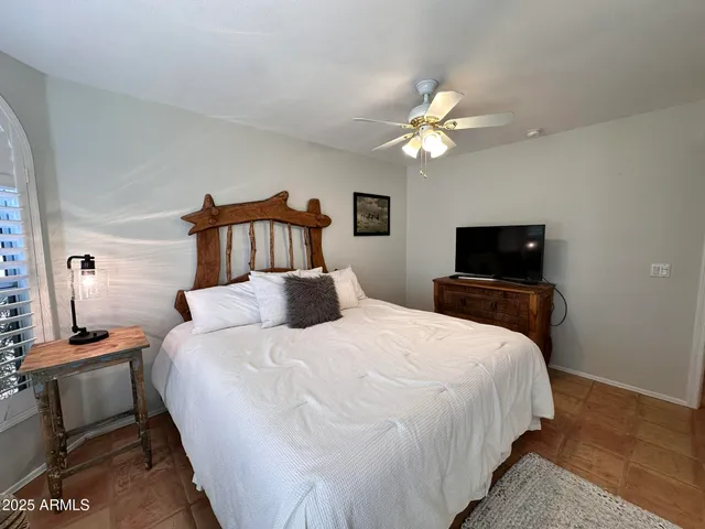 a bedroom with double bed and a tv