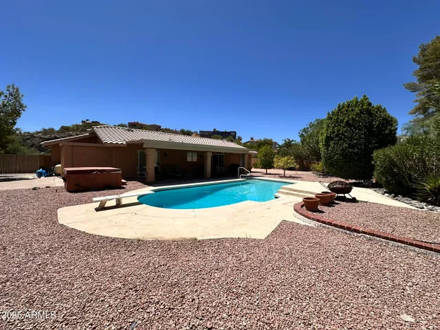 a view of a swimming pool with a yard
