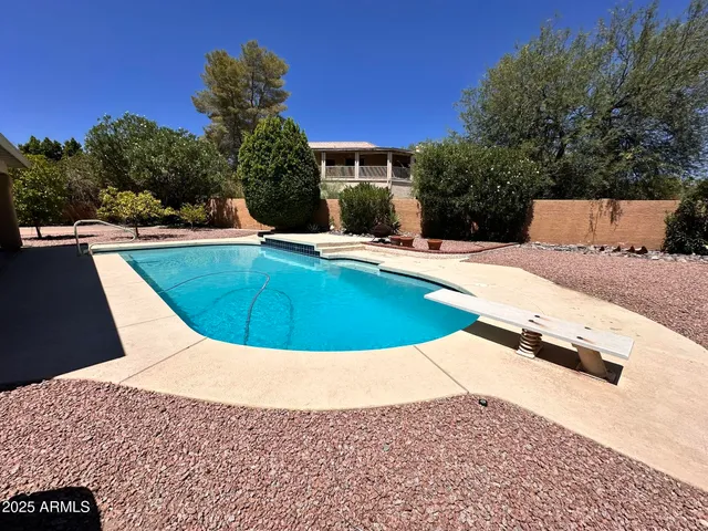 a view of a swimming pool with a lounge chairs