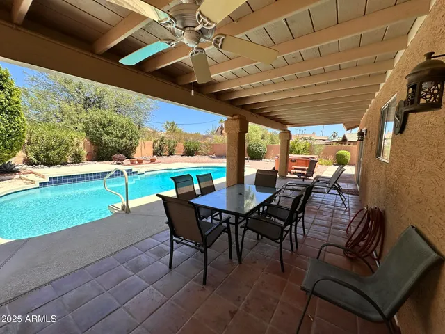 a view of a porch with furniture and a yard