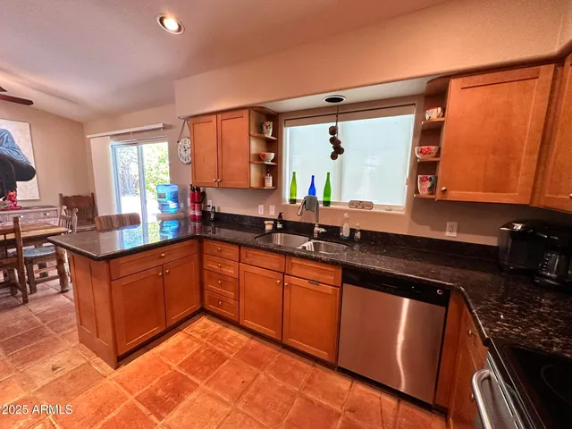 a kitchen with stainless steel appliances granite countertop sink stove and cabinets