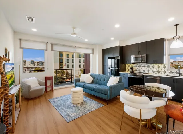 a living room with furniture and a wooden floor