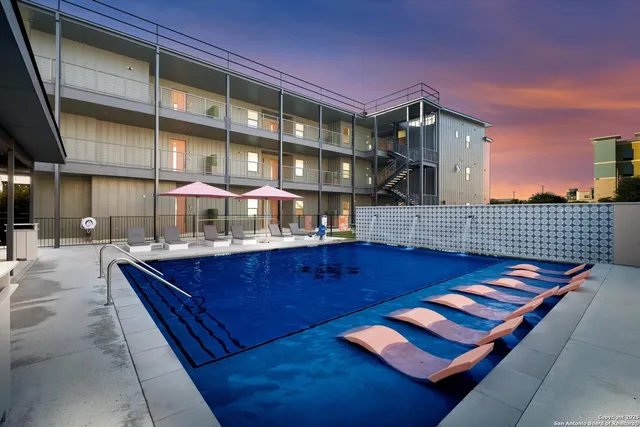 a view of backyard with a table and chairs