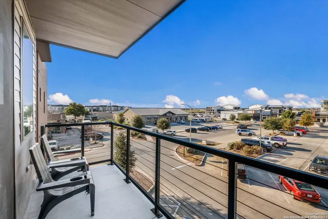 a view of a balcony with chairs