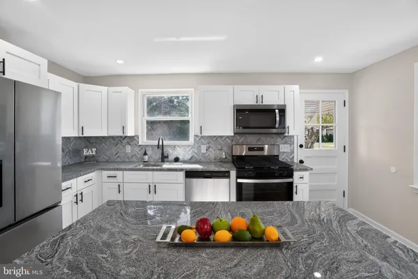 a kitchen with a sink and a stove top oven