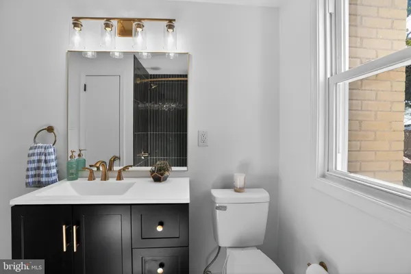 a bathroom with a sink toilet and mirror