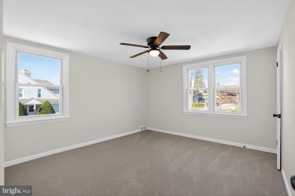 a view of room with a ceiling fan and window