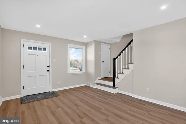 a view of an entryway with wooden floor