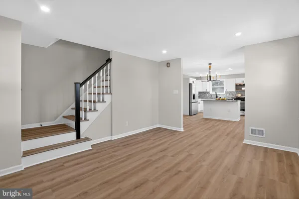 a view of a kitchen with wooden floor and electronic appliances
