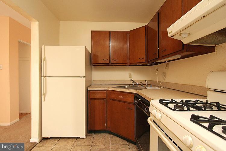 3122 Brinkley Road, Unit 303 Temple Hills, MD 20748 - Photo 18 of 30 a kitchen with a refrigerator a stove top oven