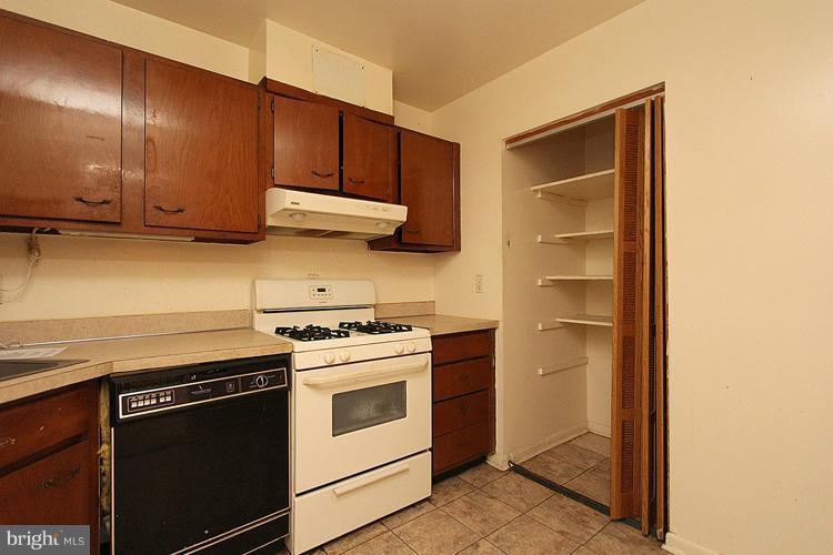 3122 Brinkley Road, Unit 303 Temple Hills, MD 20748 - Photo 25 of 30 a kitchen with stainless steel appliances granite countertop a stove and a refrigerator