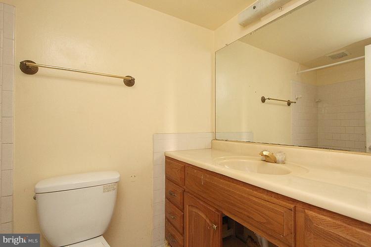 3122 Brinkley Road, Unit 303 Temple Hills, MD 20748 - Photo 26 of 30 a bathroom with a sink a toilet and shower