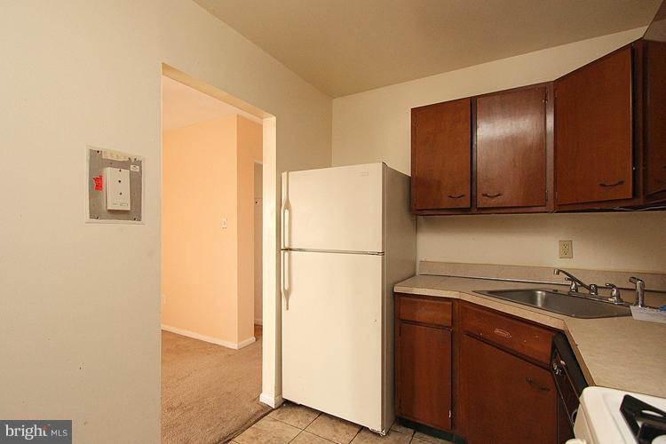 3122 Brinkley Road, Unit 303 Temple Hills, MD 20748 - Photo 4 of 30 a white refrigerator freezer sitting in a kitchen