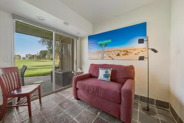 a bedroom with a bed and a flat tv screen on wall