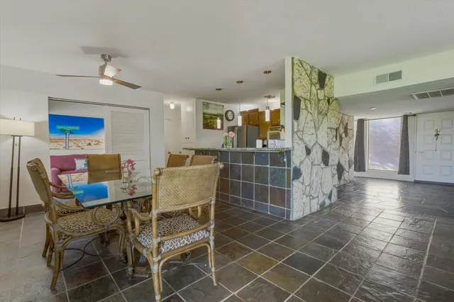 a kitchen with kitchen island a counter top space a sink and refrigerator