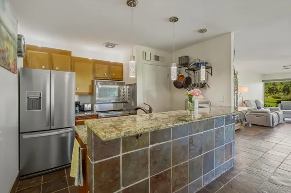 a kitchen with a stove a sink and a refrigerator