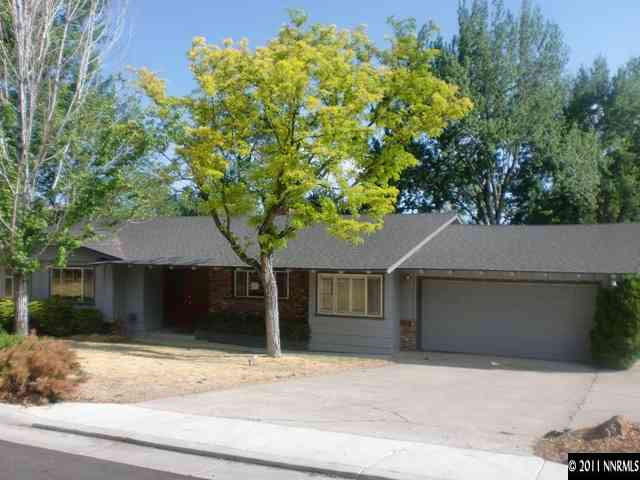 3045 West Moana Lane Reno, NV 89509 - Photo 1 of 1 a house that has a tree in front of it