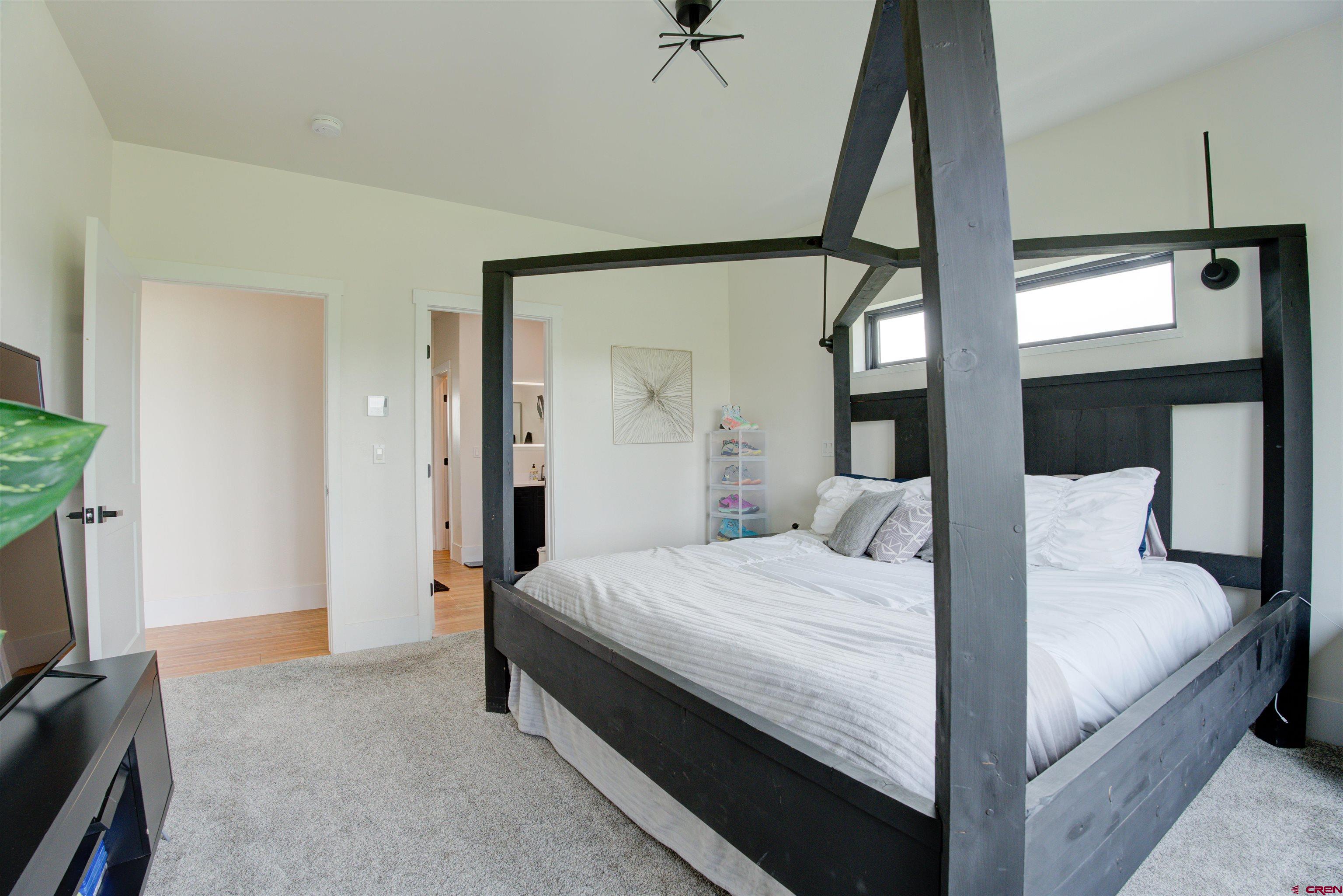 25320 Rd N.8 Loop Cortez, CO 81321 - Photo 15 of 40 a bedroom with a bed and a flat tv screen on a dresser