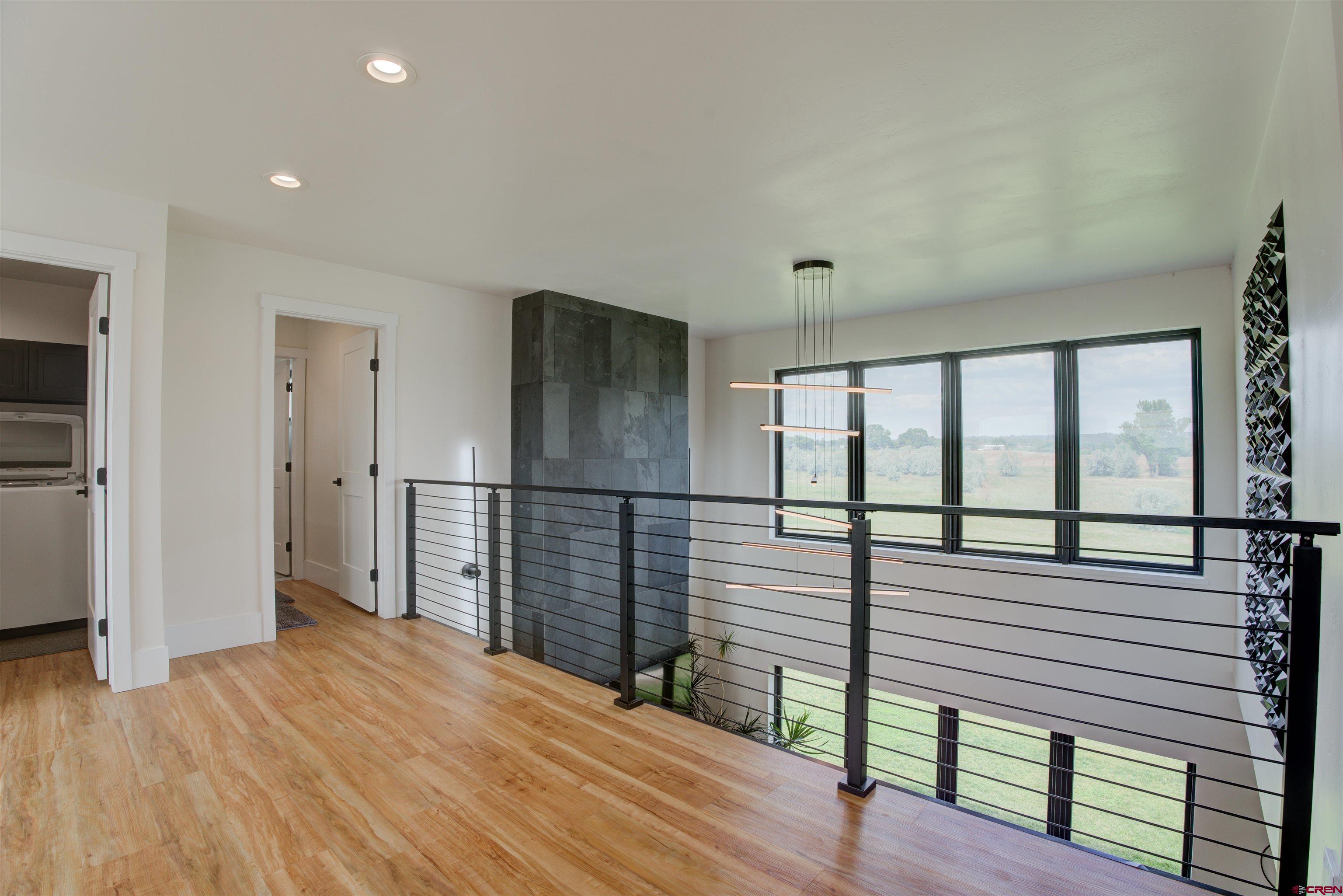 25320 Rd N.8 Loop Cortez, CO 81321 - Photo 25 of 40 a view of a hallway with wooden floor and stairs