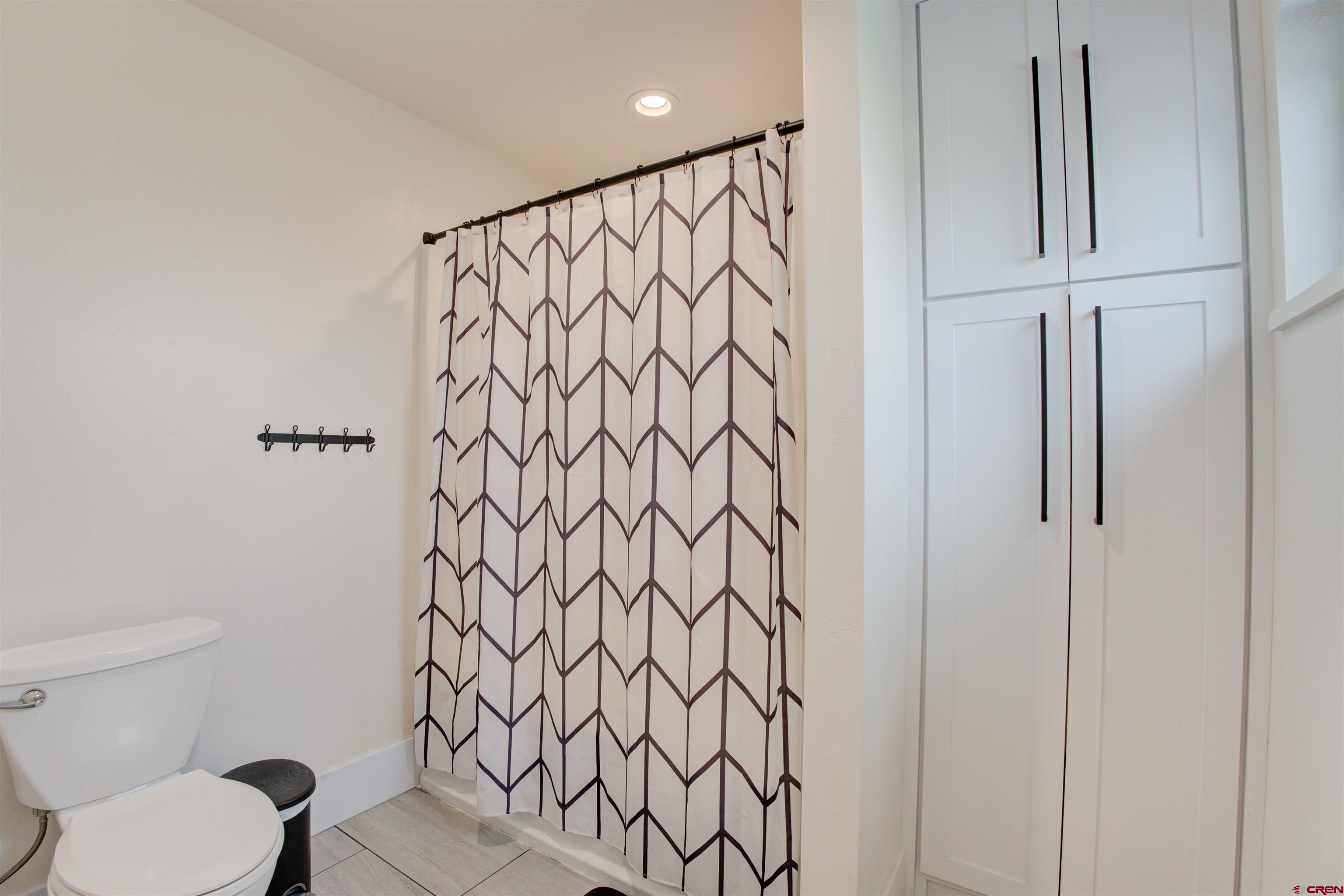 25320 Rd N.8 Loop Cortez, CO 81321 - Photo 26 of 40 a bathroom with a toilet and a shower curtain