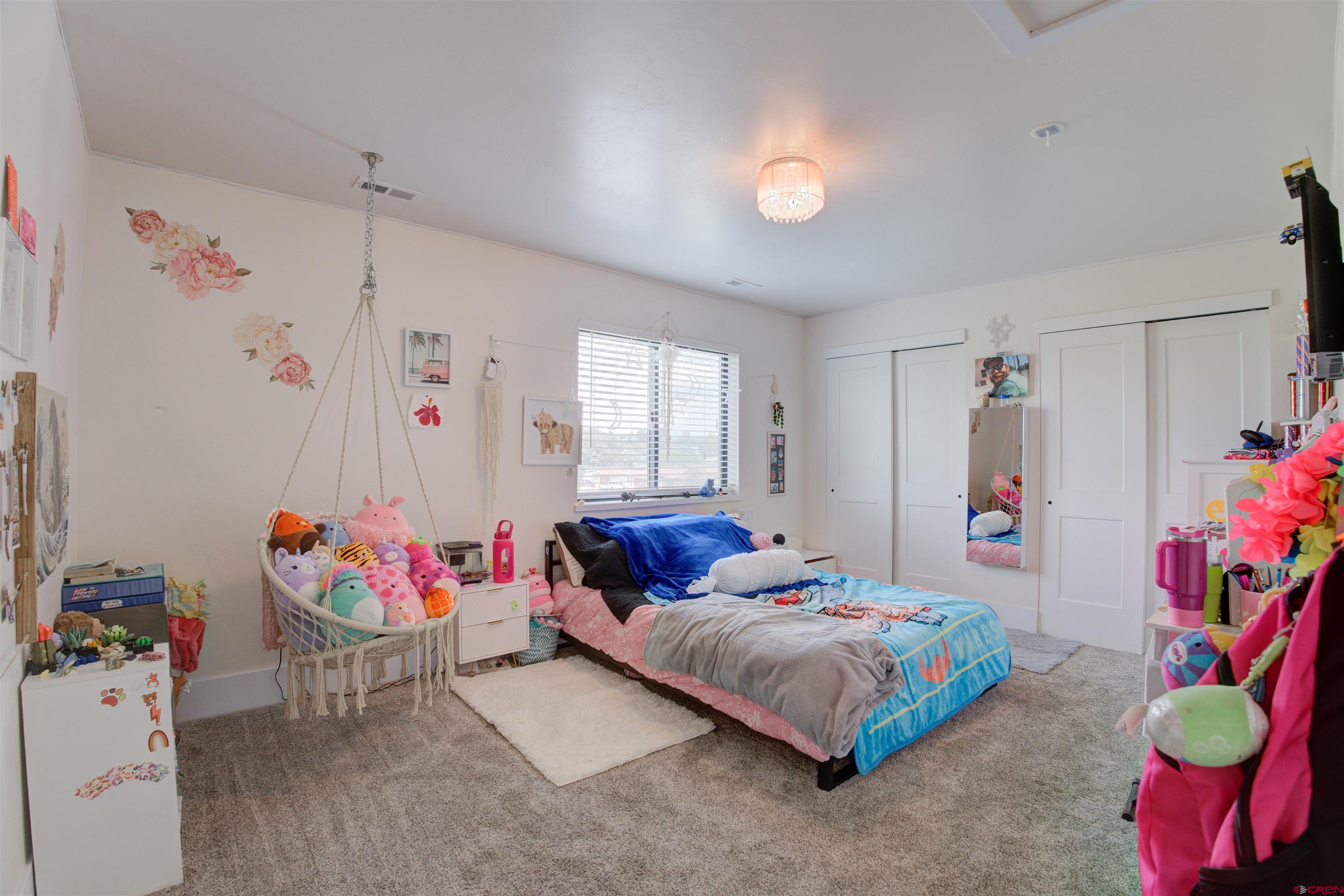 25320 Rd N.8 Loop Cortez, CO 81321 - Photo 29 of 40 a bedroom with a bed and a window