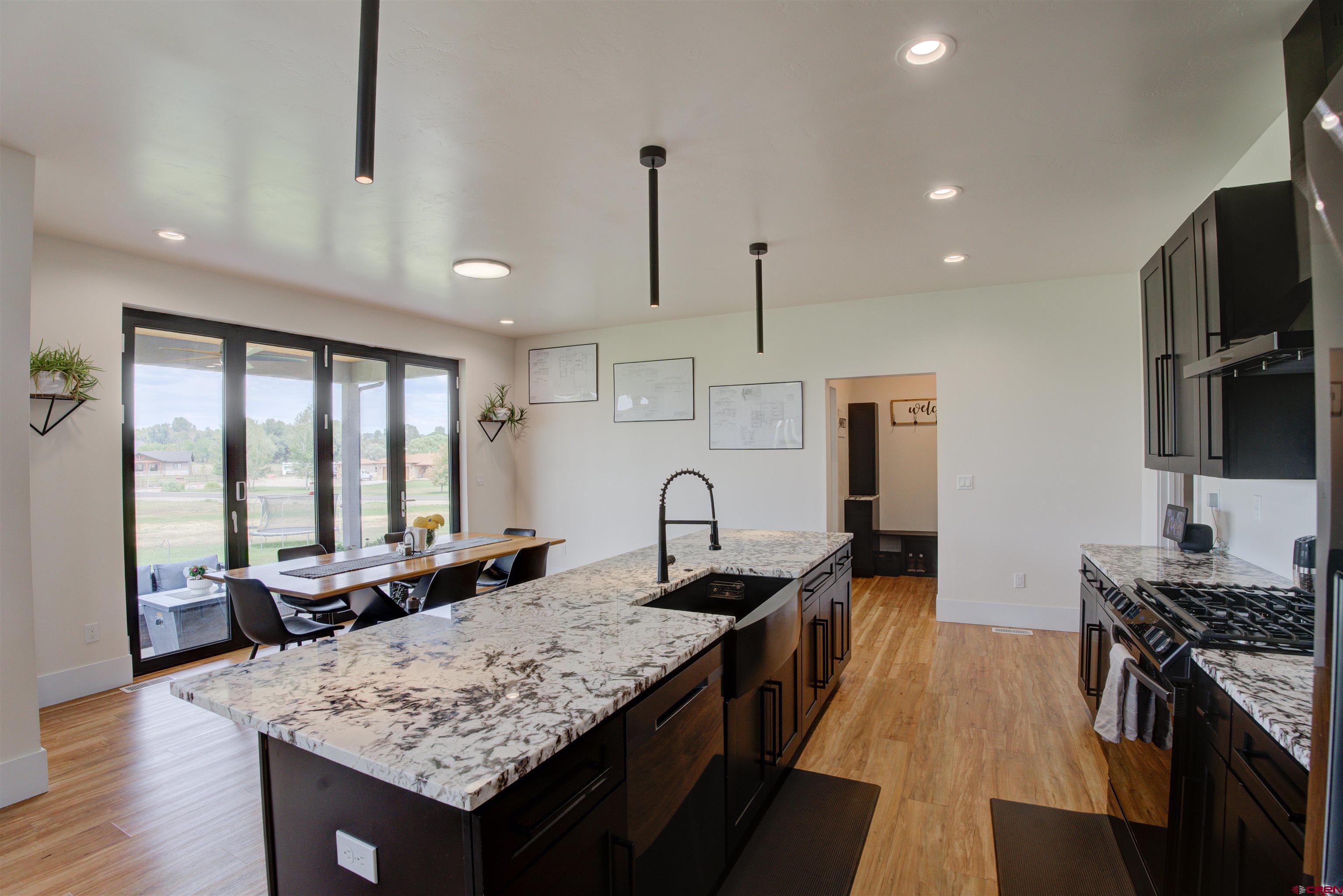 25320 Rd N.8 Loop Cortez, CO 81321 - Photo 6 of 40 a kitchen with granite countertop a stove and a sink