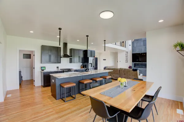 a large kitchen with a table and chairs