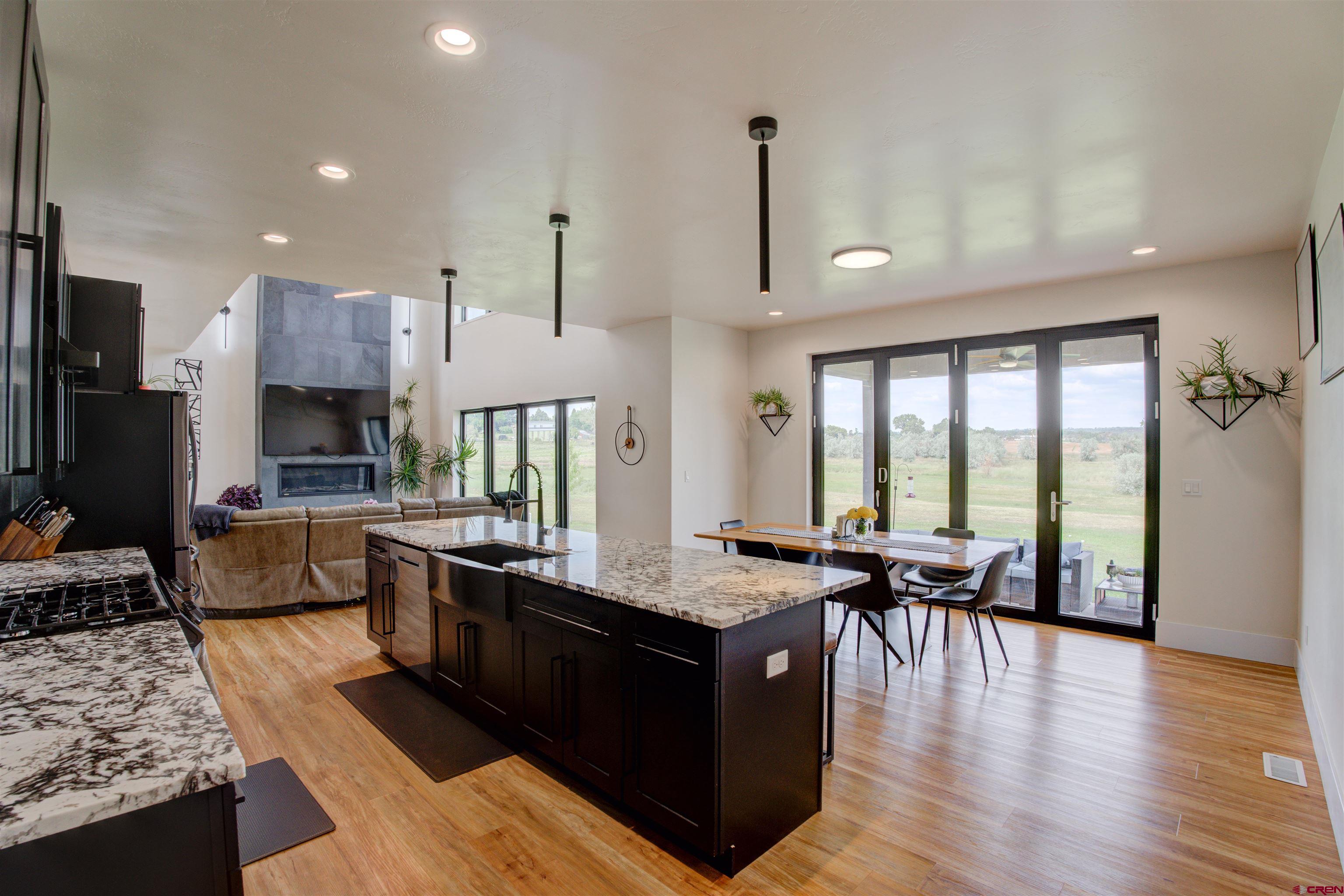 25320 Rd N.8 Loop Cortez, CO 81321 - Photo 8 of 40 a living room with stainless steel appliances granite countertop furniture wooden floor and a view of kitchen