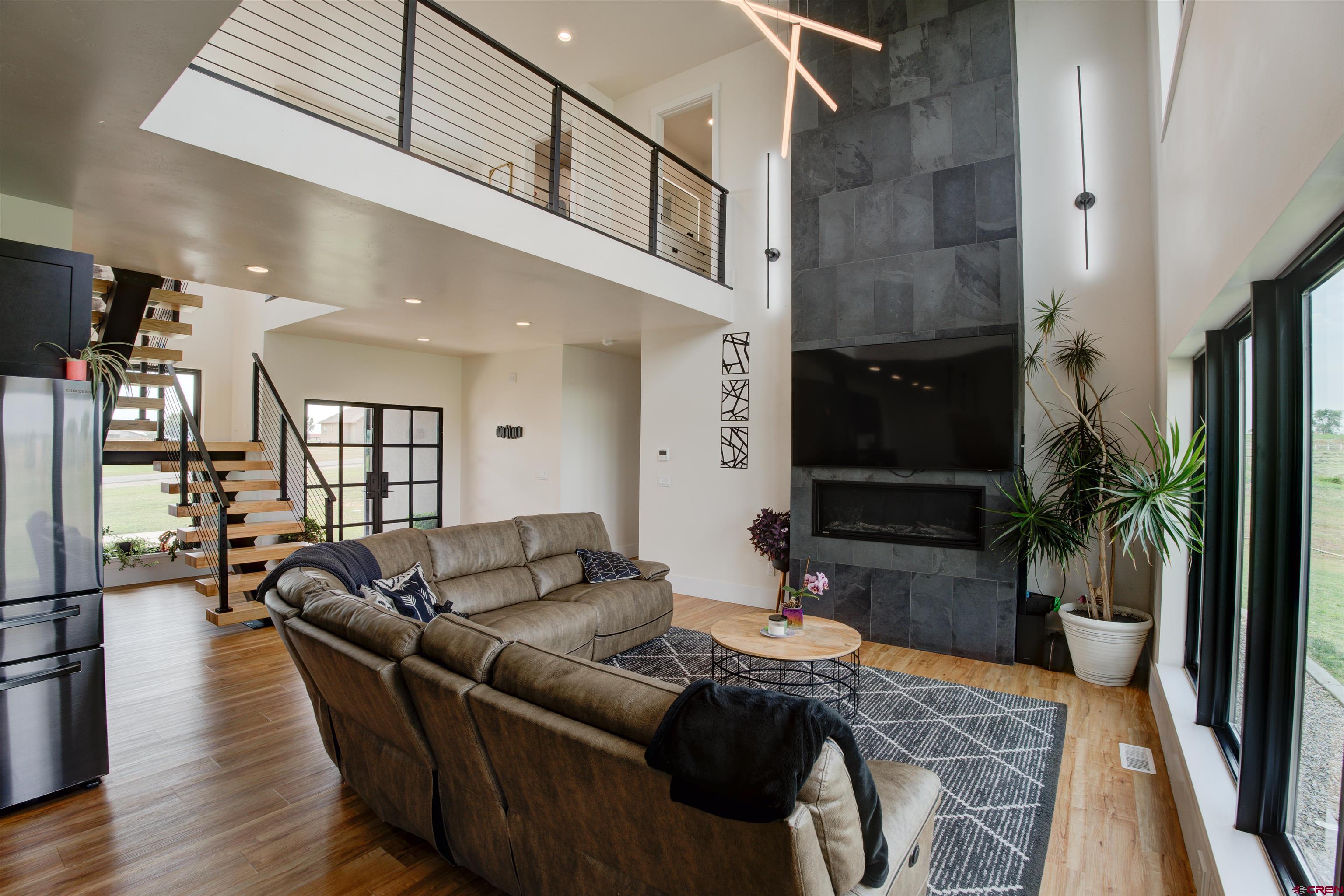 25320 Rd N.8 Loop Cortez, CO 81321 - Photo 9 of 40 a living room with furniture a flat screen tv and a potted plant